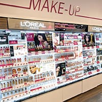 Interior view of a makeup store with contemporary LED lighting. The image highlights well-lit display areas showcasing makeup products, with bright, even lighting that enhances product visibility and contributes to a modern, clean store environment.