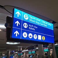 A detailed view of LED lighting installations at Dubai Airport, featuring a well-lit, modern terminal area with sleek, bright fixtures. The image highlights the advanced lighting technology and the stylish design elements contributing to the airport's contemporary ambiance.