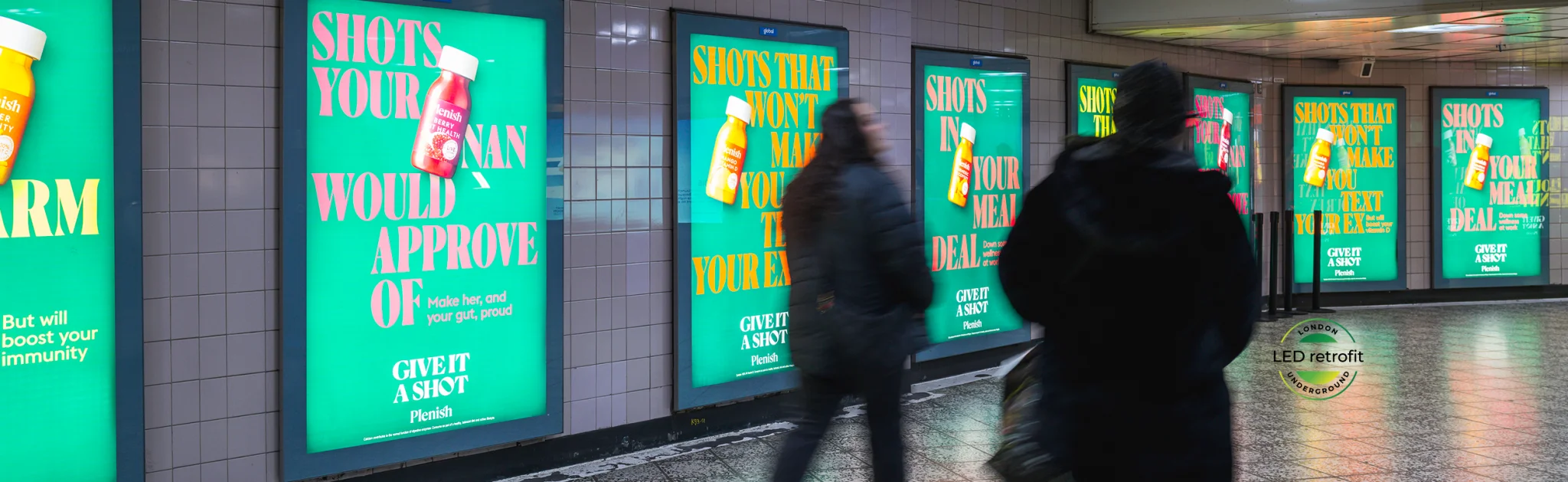 A woman walking past a billboard.